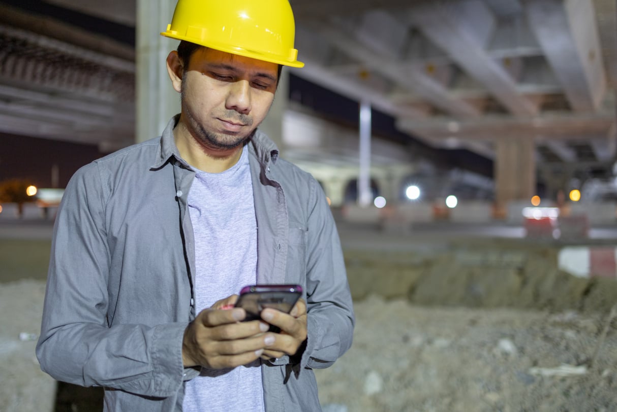 construction workers holding smartphone